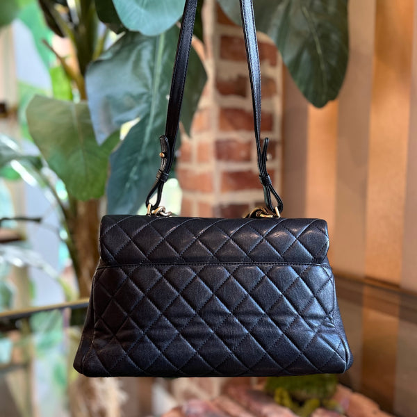 CHANEL Black Shiny Sheepskin Quilted Large Trapezio Flap Bag - The